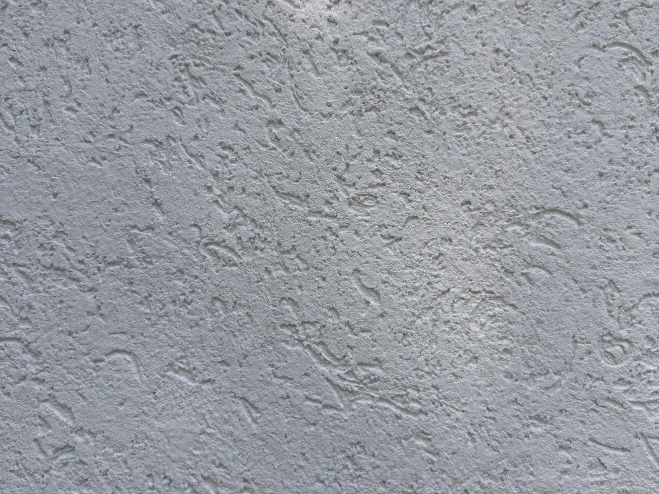 Textura de revestimiento plástico para pared exterior en Córdoba